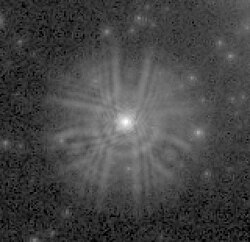 An extract from a WF/PC image shows the light from a star spread over a wide area instead of being concentrated on a few pixels.