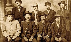 The "Dodge City Peace Commission" June 10, 1883. (Standing from left) William H. Harris (1845–1895), Luke Short (1854–1893), William "Bat" Masterson (1853–1921), William F. Petillon (1846–1917), (seated from left) Charlie Bassett (1847–1896), Wyatt Earp (1848–1929), Michael Francis "Frank" McLean (1854–1902), Cornelius "Neil" Brown (1844–1926). Photo by Charles A. Conkling.[274]
