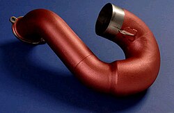 Exhaust system components with ceramic coatings having a low thermal conductivity reduce heating of nearby sensitive components.
