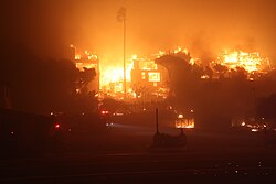 The Palisades Fire burning a structure on January 8, 2025. The Palisades Fire was a highly destructive wildfire that began in the Santa Monica Mountains of Los Angeles County.