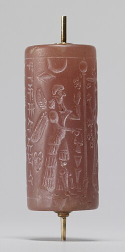 This Neo-Assyrian cylinder seal shows a ritual with winged protective deities. Walters Art Museum.