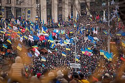 Protesters in Kyiv waving Ukrainian and European flags during the Euromaidan demonstrations in 2013