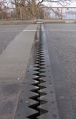 Expansion joint in a road bridge used to avoid damage from thermal expansion.