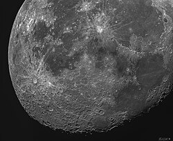 The heavily cratered surface of the Moon, particularly where no mare formed, is discernable when viewed close up, with crater ridges highlighted at the terminator and the two most prominent craters on the near side, Tycho (left) and Copernicus (top) visible, featuring long bright impact-streaks.