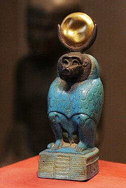 Faience statue of Thoth as baboon depicted with the moon-disk on his head.