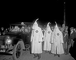 Three Ku Klux Klan members at a 1922 parade