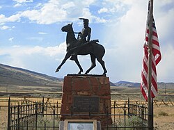 A bronze statue of Liver-Eating Johnson erected over his grave at Old Trail Town in Cody, Wyoming.