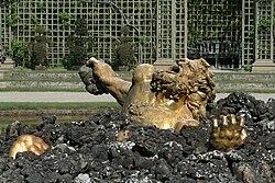 Gilt-bronze Enceladus by Gaspar Mercy in the Bosquet de l'Encélade in the gardens of Versailles