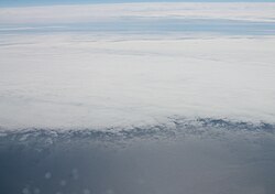 Partial cloud cover over the North Atlantic Ocean.
