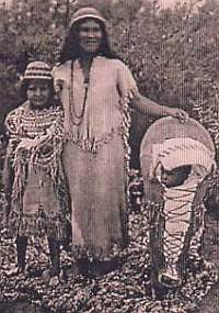 Southern Paiutes at Moapa, Nevada, wearing traditional Paiute basket hats, while the baby is swaddled in traditional rabbit robes in a Paiute cradleboard.