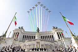 The Frecce Tricolori, with the smoke trail representing the national colours of Italy, above the Victor Emmanuel II Monument in Rome during the celebrations of the Festa della Repubblica, an Italian public holiday and Italy's National Day[1]
