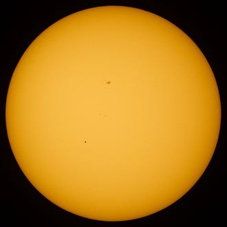 The transit of Mercury on May 9, 2016. Mercury is visible to the lower left of center. A sun spot is visible above center.