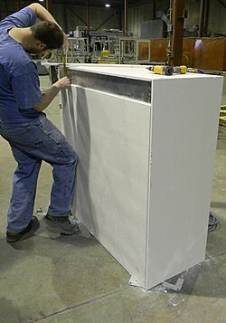 Calcium-silicate passive fire protection board being clad around steel structure in order to achieve a fire-resistance rating