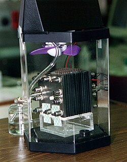 Demonstration model of a direct-methanol fuel cell. The actual fuel cell stack is the layered cube shape in the center of the image.