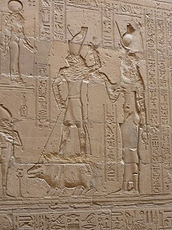 Horus spears Set, who appears in the form of a hippopotamus, as Isis looks on