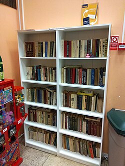Bookshelf for free exchange in a supermarket, Riga, Latvia