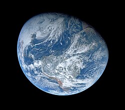 The first image taken by humans of the whole Earth, probably photographed by William Anders.[57] (time tag: 003:42:55) South America is visible in the lower half.