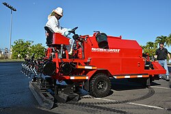 Machine sealcoating asphalt pavement