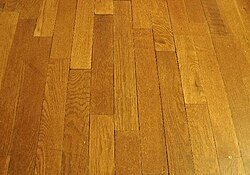 Wood can be cut into straight planks and made into a wood flooring.