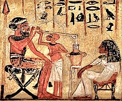 Ancient Egyptian painting, 18th dynasty, reign of Akhenaten, c. 1300 BC, showing Syrian mercenary drinking beer through a straw. Egyptian Museum of Berlin