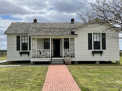 Cash's boyhood home in Dyess, Arkansas, where he lived from the age of three in 1935 until he finished high school in 1950. The property, pictured here in 2021, is listed on the National Register of Historic Places. The home was renovated in 2011 to look as it did when Cash lived there as a child.