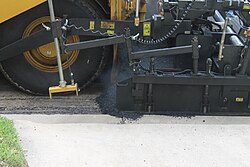 Asphaltic concrete laying machine in operation in Laredo, Texas