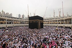 Muslim pilgrims circumambulate the black cube of the Kaaba in the Al-Haram Mosque