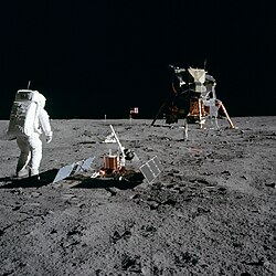 Astronaut Buzz Aldrin in life-supporting suit looking back at the first lunar habitat and base, the Lunar Module Eagle of Tranquility Base, during Apollo 11 (1969), the first crewed Moon landing