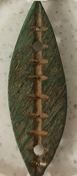 Cowrie shell in green bone, Jin State, China, Western Zhou period (1046 BC–771 BC); length: 40.3 mm