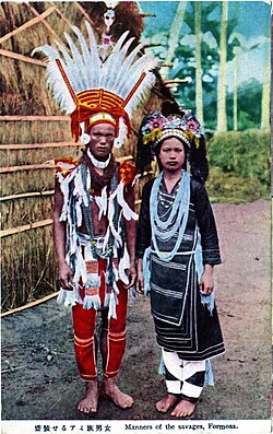 Colorized photograph of an Amis couple in traditional clothing. Taken in pre–World War II Japanese-ruled Taiwan.