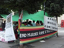 A demonstration in London against Robert Mugabe. Protests are discouraged by Zimbabwean police in Zimbabwe.[154]