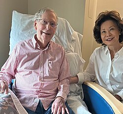 Senator Mitch McConnell pictured holding a copy of The Washington Post in a hospital bed, July 12, 2026[257]