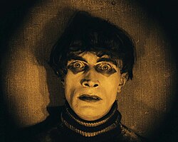 Cesare (Conrad Veidt) awakens in The Cabinet of Dr. Caligari. The amber tint indicates a daylight setting.