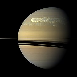 A global storm girdles the planet in 2011. The storm passes around the planet, such that the storm's head (bright area) passes its tail.