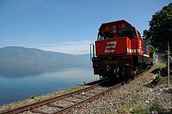 A train passes Lake Singkarak.