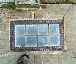 Vault lights made of load-bearing glass bricks and embedded into a pavement in Burlington House, London.
