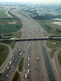 Highway 401, in Ontario, Canada, uses a divided highway, collector / express system to separate local traffic from longer-distance travellers.