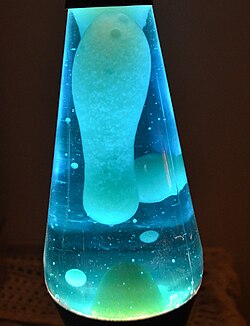 A lava lamp contains two immiscible liquids (a molten wax and a watery solution) which add movement due to convection. In addition to the top surface, surfaces also form between the liquids, requiring a tension breaker to recombine the wax droplets at the bottom.
