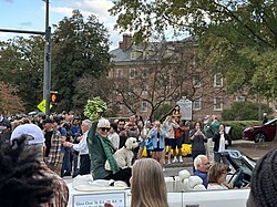 Close (seated with her dog) leading the College of William & Mary's 2023 homecoming parade