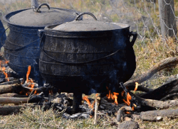 Food being cooked in a cauldron above fire in South Africa.