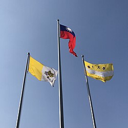 From left to right: The flags of Vatican City, Republic of China (Taiwan), and the university flag displayed in the university.