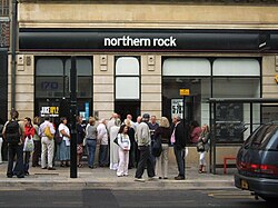 People queueing outside a Northern Rock branch in the United Kingdom to withdraw their savings during the financial crisis