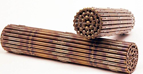Two CANDU fuel bundles: Each about 50 cm in length and 10 cm in diameter. Notice the small appendages on the fuel clad surfaces