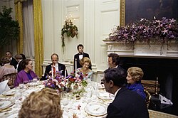 First Lady Betty Ford, President Valery Giscard d'Estaing of France, Choreographer Martha Graham, Actor Clint Eastwood, Fashion Designer Adele Simpson, and Jazz Pianist Earl Hines Seated in the State Dining Room