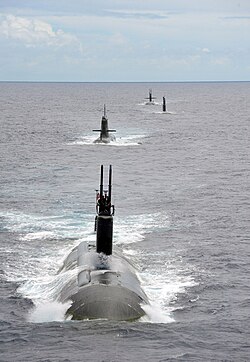USS Charlotte, a Los Angeles-class submarine runs with submarines from partner nations during RIMPAC 2014.