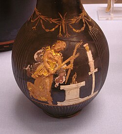 Hecate holding two torches and dancing in front of an altar, beyond which is a cult statue, c. 350–300 BC, red-figure vase, Capua, Italy