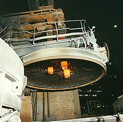 The roof of an arc furnace removed, showing the three electrodes