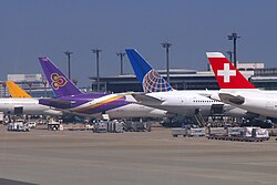 Aircraft of various airlines parked side by side at Tokyo Narita Airport, Japan in April 2012