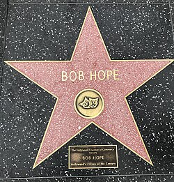 Bob Hope's live performance star with a rectangular plaque beside it that reads "The Hollywood Chamber of Commerce / honors / BOB HOPE / Hollywood's Citizen of the Century