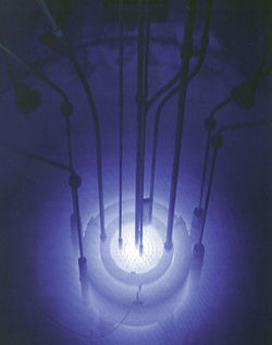 Self-illumination of a nuclear reactor by Cherenkov radiation.